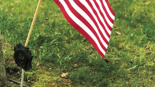 American flags designate the graves of veterans. Enterprise photo by Amy Hubbell