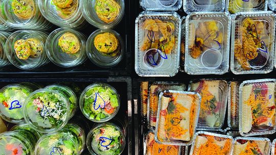 A bird’s eye view of the meals to-go at Peshawbestown’s St. Kateri Tekakwitha Catholic Church last week Thursday. Pictured are the stacks of crates filled with chocolate chip cookies, pumpkin cheesecake, chicken tenders, and sweet potato and black bean enchiladas. Courtesy photo