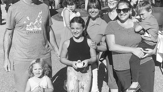 The Dembowske family of Suttons Bay showed up in force for the Lake Leelanau bridge walk. From left are patriarch Bob Dembowske; Isla Korson, 3; duck race winner Edyn Gallagher, 8; Ashley Gallagher, who is holding her daughter, Sutton, 3; Dee Dembowske; and Shannon Korson, who is holding Z...