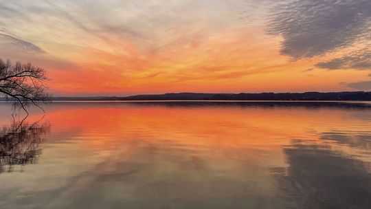 A warm colored sunset over Lake Leelanau is seen at Bingham Boat Launch on the evening of the winter solstice last Thursday. The celebration of the winter solstice marks the shortest day of the year and the longest night in the hemisphere. Enterprise photo by Meakalia Previch-Liu