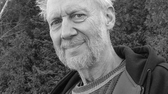 Porter Abbott, a research professor emeritus at the University of California, Santa Barbara, sits on the beach near the waters of Lake Michigan. Abbott moved to Leelanau County full time after teaching at the university’s English department for many years, fulfilling his lifelong goal of r...
