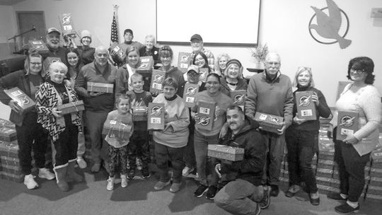 Above, members of the Leelanau Community Church assembled 300 Operation Christmas Child boxes Tuesday night
