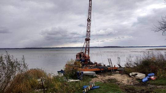 The barge, currently situated partly on state-owned Lake Michigan bottomlands and partly on private land north of Suttons Bay, was towed ashore last year following the issuance of seven criminal charges against Balcom in June.