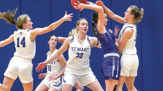 Lake Leelanau St. Mary defenders Delana Kirt (left), Leah Fleis (middle), and Cathryn Mikowski (right) pressure a Gaylord St. Mary player in the first half of Monday night’s game. The Eagles went into halftime up 21-15. Enterprise photo by Brian Freiberger