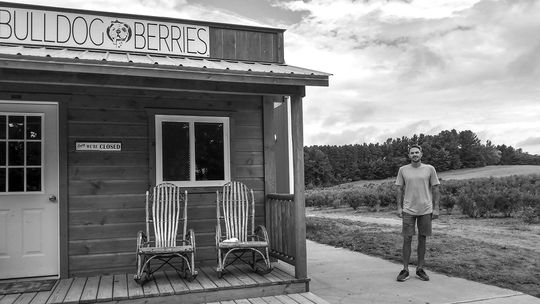 Nick Billings stands near the storefront at his blueberry farm, Bulldog Berries. Billings started with five acres of farm in 2012, and today, he has 25 acres of blueberries in 12 different varieties. Enterprise photo by Zachary Marano