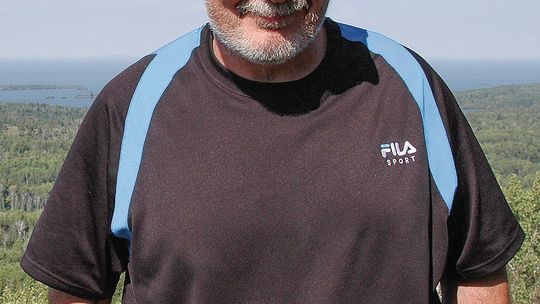 Jim DuFresne, author of “The Trails of M-22: 48 of the Most Beautiful Paths Along Michigan’s Most Beautiful Highway,” stands at Isle Royale National Park. DuFresne recently retired after 45 years of writing guidebooks and settled down at the family cottage in Elk Rapids. DuFresne’s bibliog...