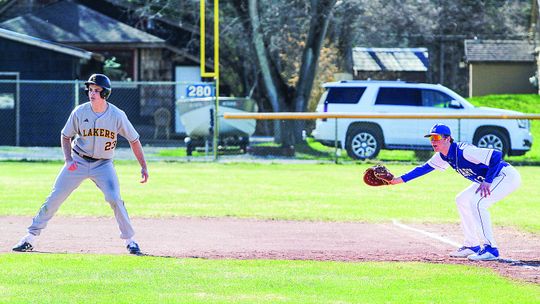 Enterprise photos by Brian Freiberger St. Mary first baseman Cody Couturier tries to hold Glen Lake base runner Joey Roux on first.