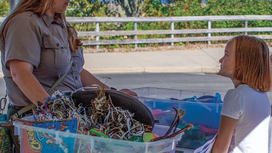 Casey Kilian, educational technician for the National Park Service, shares information on “keeping rivers and lakes clean.” Enterprise photo by Mike Anderson