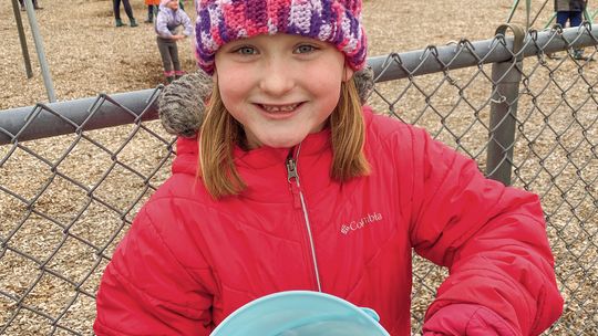 Claire Zionskowski of Elmwood Township was among the many children who bundled up Saturday for the Cedar Eggstravaganza egg hunt Saturday. Courtesy photo