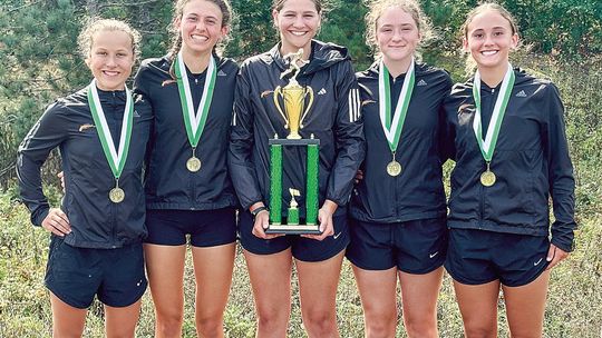 The Leland girls cross country took some hardware home after finishing first as a team at the 18th annual Logger Invitational in Boyne City on Saturday. From left to right: Natalie Burpee, Ella Knudsen, Alyssa Korson, Lorna wiesen, and Sophie Grinage. Courtesy photo