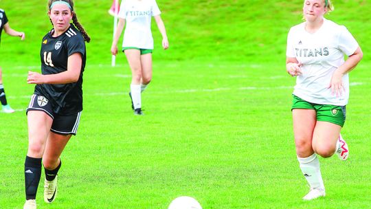 Glen Lake attacker Abbi Steffke (left) attempts a shot against TC West JV on Monday.