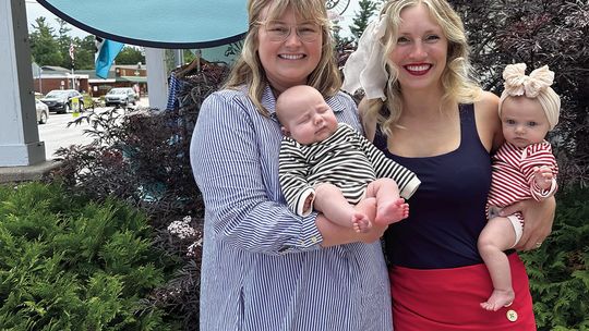 Cottonseed Apparel owners Lizzie Gray (left) and her son, Rory, and Laurenn Rudd (right) with her daughter, Quinn Ankerson, are pictured at the store in Glen Arbor last week. The two business partners became pregnant around the same time and have been bringing their babies into work since...