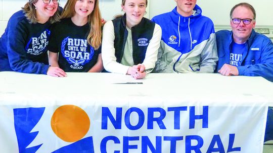 The Couturier family celebrates their daughter Kendra Couturier committing to North Central Michigan College in Petoskey last week. Photo courtesy of Brittany Rosendall