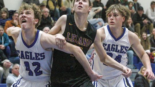 Lake Leelanau St. Mary sophomore Cody Couturier and senior Luke Gallagher box out a Leland player last week.
