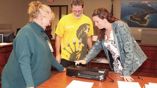 Leelanau County Deputy Clerk Lynndell Drzewiecki and Kasson Township Shiree Nelson and Jon Hurst count early voting ballots Tuesday night at the Government Center in Lake Leelanau. Enterprise photo by Brian Freiberger