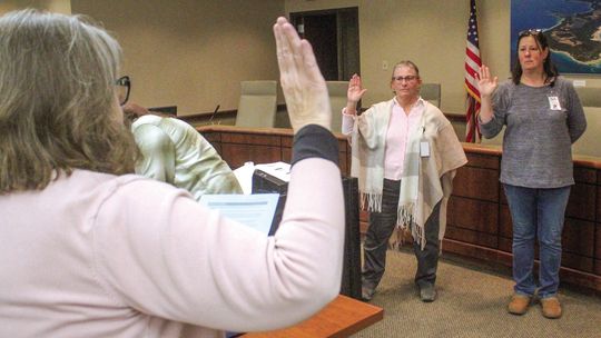 Deputy Lyn Drzewiecki (left) and Deputy Alison Middleton (right) sworn in during the presidential primary election on Tuesday. Drzewiecki and Middleton are trained election workers and served as the Receiving Board for Early Voting. Enterprise photo by Brian Freiberger