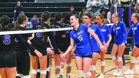 Lake Leelanau St. Mary and Leland show sportsmanship after a hard fought volleyball game Tuesday. Enterprise photo by Brian Freiberger