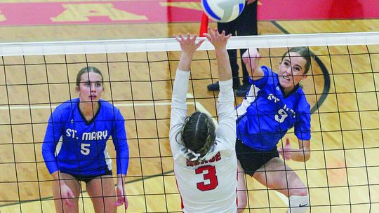 Lake Leelanau St. Mary junior Maggie Ursu spikes the ball against Suttons Bay Wednesday during a district semifinal game. Enterprise photo by Brian Freiberger