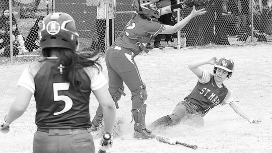 Lake Leelanau St. Mary freshman Lydia Bramer slides into home base during a 16-0 win over Suttons Bay on Tuesday. Enterprise photo by Brian Freiberger