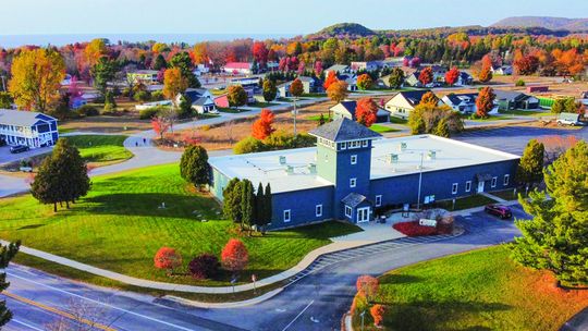 Empire sits on the shores of Lake Michigan in peak fall color earlier this week. The Sleeping Bear Dunes National Lakeshore Philip A. Hart Visitor Center is pictured in front. Enterprise photo by Brian Freiberger (FAA Part-107 Drone license)