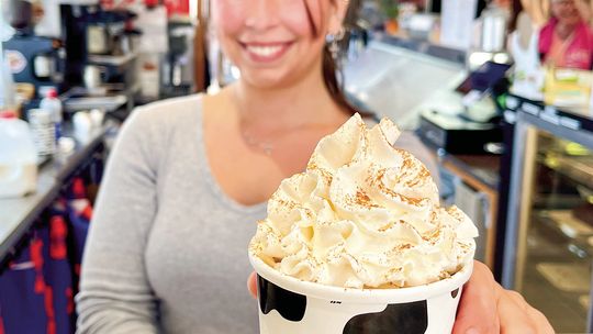 Leland Harbor House Store Manager Sophia Graham is pictured serving one of their fall favorites, a pumpkin Spice Latte (PSL) sundae. It’s made with pumpkin ice cream, a shot of espresso, whip, and cinnamon on top. Enterprise photo by Meakalia Previch-Liu