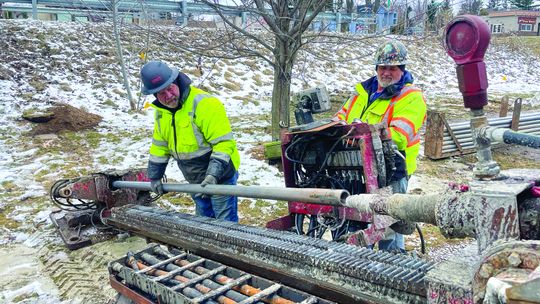 Mike Young and Joe Hess uses a trenching machine, which creates a narrow and deep channel for fiber optic cables to be installed under the Lake Leelanau Narrows. Enterprise photo by Brian Freiberger