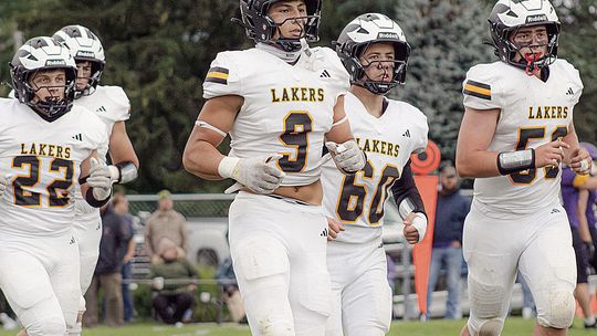 Several Glen Lake football players run off the field against Frankfort earlier this season. Glen Lake won its third straight game of the season in a 46-0 route of Harbor Springs. Photo courtesy of Meredith McNabb