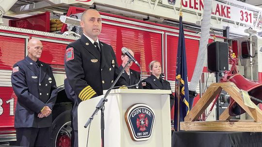 Glen Lake Fire Chief Bryan Ferguson is pictured speaking at their 9/11 commemoration service held last week Wednesday morning at the station. Enterprise photo by Meakalia Previch-Liu