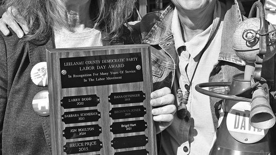 Sam Getsinger, right, accepts a Freedom of Speech Award at the Leelanau Democrats Labor Day 2021 picnic, with party co-chair Brigid Hart. Enterprise file photo