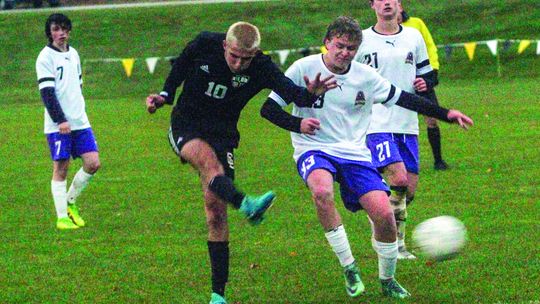 Glen Lake junior Hunter Cox launches a rocket past Pentwater’s goalkeeper to go up 5-4 in extra time and seal the win for the Lakers. Enterprise photo by Brian Freiberger