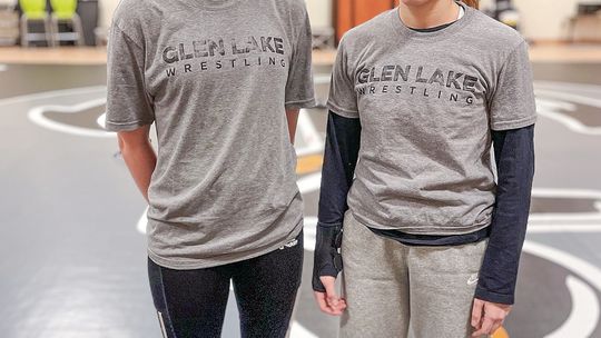 Glen Lake freshman Peace Hawley-Joppich (left) and junior Emily Alaimo pose for a photo before practice Tuesday. Enterprise photo by Brian Freiberger