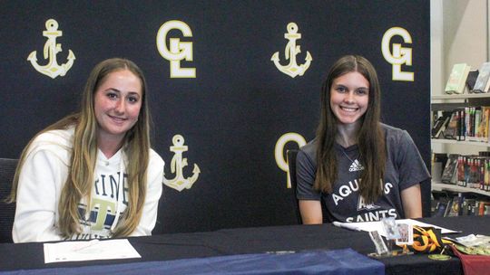 Glen Lake seniors Kariesue Taghon and Paige Steffke signed their letterof- intent to Aquinas College and Trine University Enterprise photo by Brian Freiberger