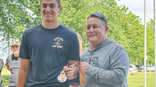 Glen Lake senior Alex Eaton accepts a medal for his exceptional performance at the state competition on Saturday. Eaton along with his teammates Henry Plamondon and Ethan Verschaeve shot 25 straight. Courtesy photo
