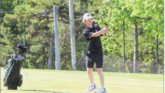 Glen Lake freshman Joel Martin finds himself out of the rough and onto the green during a nine hole Northwest Conference match at the Leland Country Club on Tuesday. Martin finished third on the team with a new highscore of 43. Enterprise photo by Brian Freiberger