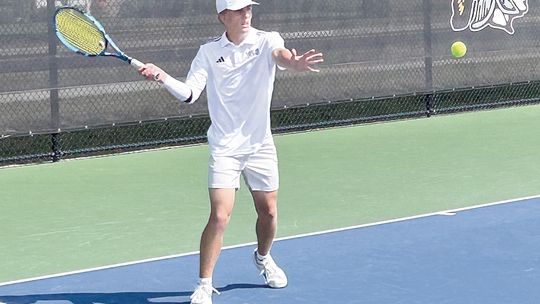 Glen Lake senior Ben Romzak hits a forehand shot against Zeeland West on Saturday during a tournament at TC Central. Courtesy photo