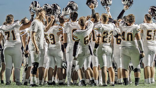Lake raises their helmet before competing in the first game of the season against Manton.