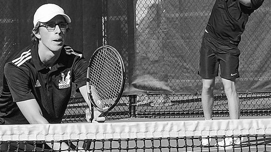 Glen Lake senior Ben Selby serves while Lake Leelanau St. Mary junior Oliver Mitchell prepares for a return against TC St. Francis Wednesday. Enterprise photos by Brian Freiberger