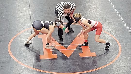 Glen Lake junior Emily Alaimo, left, takes the mat for the first wrestling match in 22 years for the Lakers. Courtesy photo
