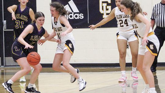 Glen Lake junior Hailey Anderson and Leland junior Elli Miller battle earlier this month in a Northwest Conference game. Both Leland and Glen Lake girls basketball have had their ups and downs, but are beginning to find their stride. Enterprise photo by Brian Freiberger