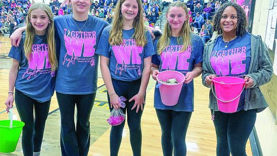 Glen Lake middle schoolers Cadence Bachelder, Katie Toth, Adeline Gruffey, Josalyn Eaton, and Selah Hall collet donations for Glen Lake girls basketball cancer fundraiser 'Together We Fight' basketball game against Onekama on Friday. Enterprise photo by Brian Freiberger