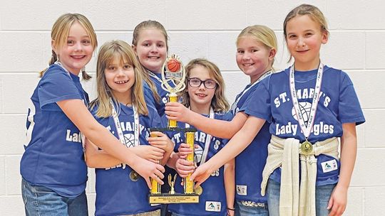 Lake Leelanau St. Mary elementary students Meadow Beman, Eisley West, Adeline Morio, Eliza Plamondon, Mary Grant, Ariana Denoyer with tournament trophy after a successful winter basketball season. Courtesy photo