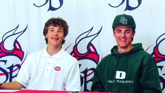 Suttons Bay seniors Finn Mankowski (left) and Lucas Gordon (right) sign their letter-of-intent to play soccer and baseball at St. Cloud State University (Minnesota) and Delta College last week. Enterprise photo by Brian Freiberger