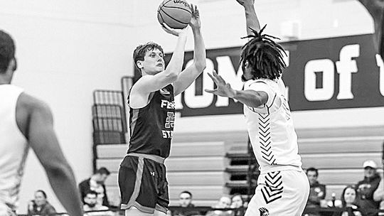 2016 Glen Lake graduate Reece Hazelton makes a contested 3-pointer earlier this season for the Ferris State Bulldogs.