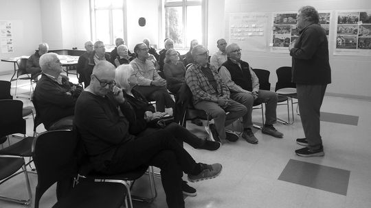 Suttons Bay residents watch and listen to a presentation by Peninsula Housing President Larry Mawby at the Suttons Bay-Bingham Fire Department May 2. This “housing workshop” served as an opportunity to exchange ideas on the area’s housing needs. Enterprise photo by Zachary Marano.