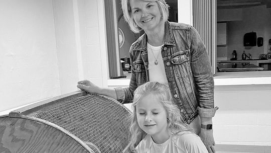Lori Schaub pulls a winning ticket out of the bin with a young helper. Courtesy photo