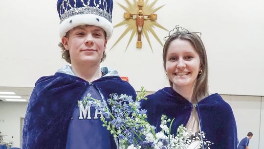 Lake Leelanau St. Mary senior Eli Kelenske (left) Sarah Bunek (right) became royalty during the boys basketball game against TC Christian on Friday as they were named winter homecoming king and queen. Courtesy photo