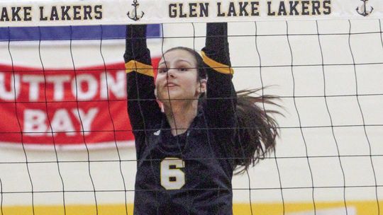 Glen Lake sophomore Avery Flores blocks a Benzie attack during a homecoming volleyball game Thursday.