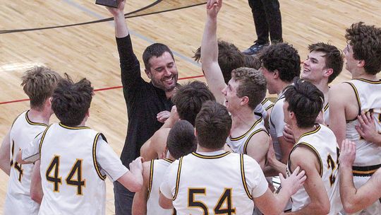 The Glen Lake boys basketball team celebrates after capturing its first regional championship since 2018. Enterprise photos by Brian Freiberger