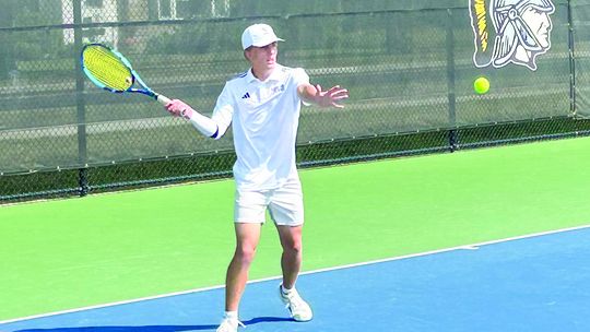 Glen Lake senior Ben Romzak returns a serve during a match against TC Central earlier this fall. Courtesy photo
