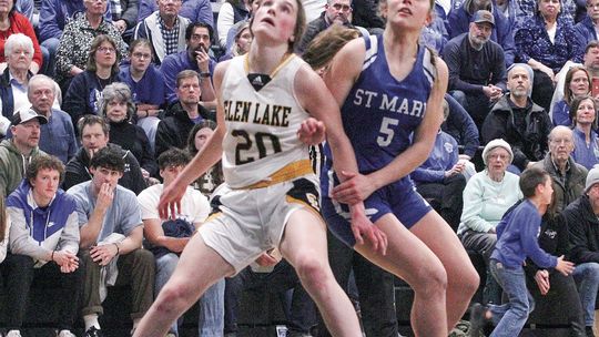 Glen Lake sophomore Lydia Fosmore and St. Mary senior Kyla Barnowski battle for a rebound during a district final game last season. Enterprise photo by Brian Freiberger